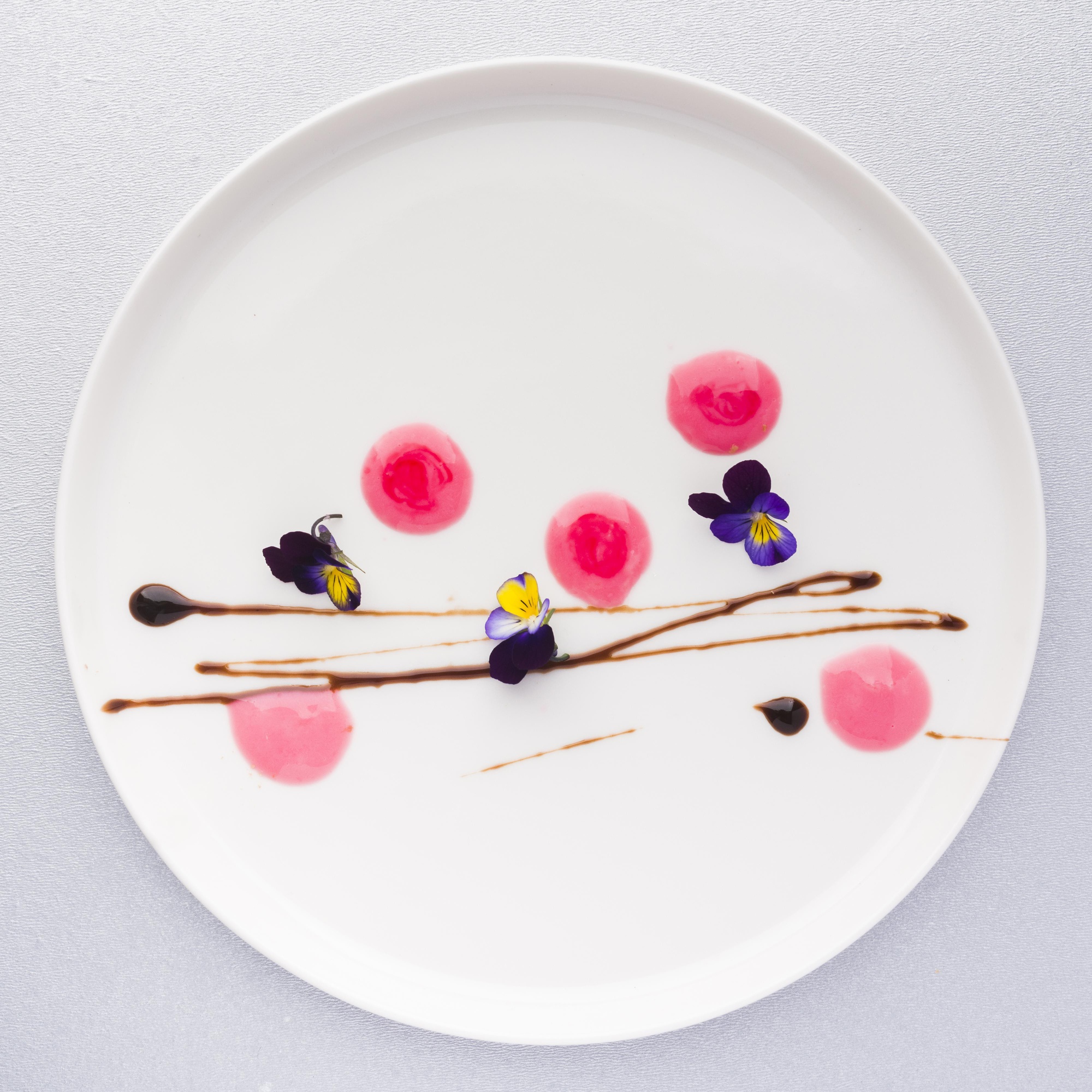 Close-up of plated dessert with geometric garnish